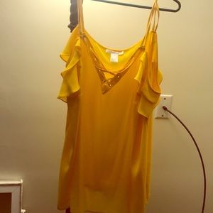 Yellow blouse lace up off shoulder.